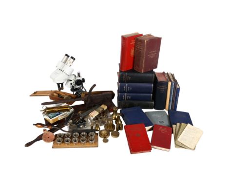 A collection of scientific and medical instruments, including a microscope, guillotine, brass bell weights, etc, and a group 