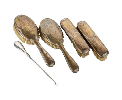 An Art Nouveau silver-backed 5-piece brush and button hook set