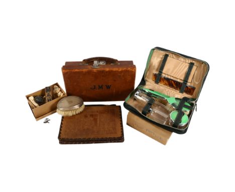 A small leather case, 30cm across, an Egyptian tooled leather stationery wallet, brooch, silver-backed brush, Art Deco green 