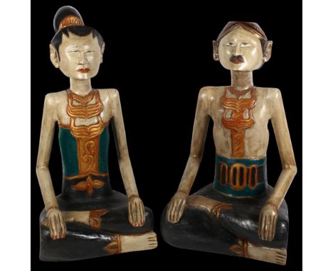 A pair of modern carved wood seated Thai figures, unsigned, H65cm (2)