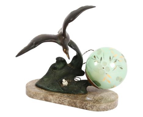 An Art Deco style table lamp, spelter figure of a bird in flight, green glass shade, resting on ornate marble plinth, H23.5cm