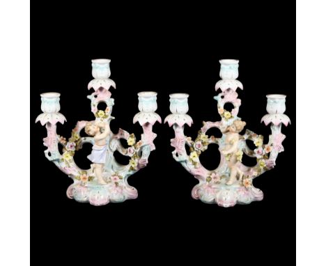 2 similar German porcelain 3-branch candelabra, each with cherub and floral decoration, German factory maker's marks to both,