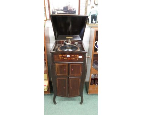 An Edwardian upright "FULLOTONE" wind up gramophone.  Fitted record storage to base, speaker doors above and with boxwood and