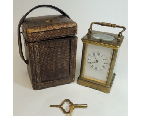 A late 19th Century French brass cased carriage clock with repeat mechanism.  Having white enamel dial with black Roman numer