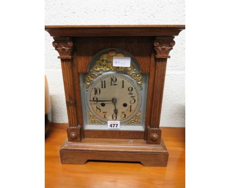 An Edwardian mantel clock in oak architectural case 