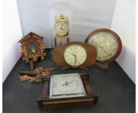 An anniversary timepiece under glass dome, a small cuckoo clock, two mantel timepieces and an anaeroid barometer (5) 