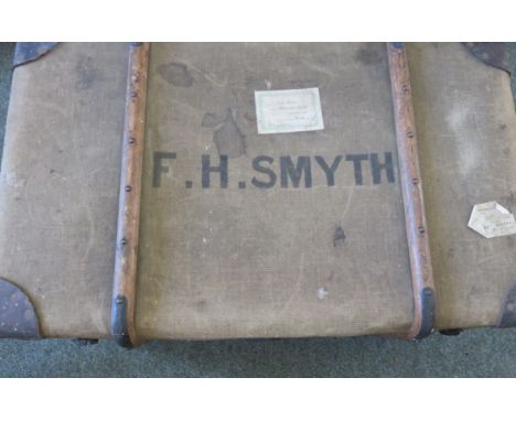 An early 20th Century travelling trunk, canvas covered with leather corners 