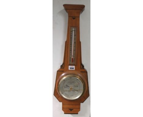 A decorative walnut barometer with thermometer 