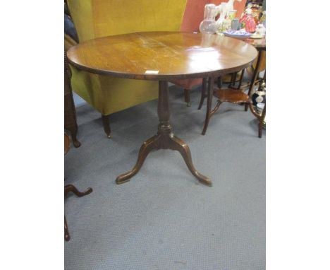 A 19th century oak tilt top occasional table on a tripod base 