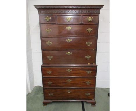 A George III mahogany chest on chest having a moulded and blind fret carved cornice, over three inline drawers and three grad
