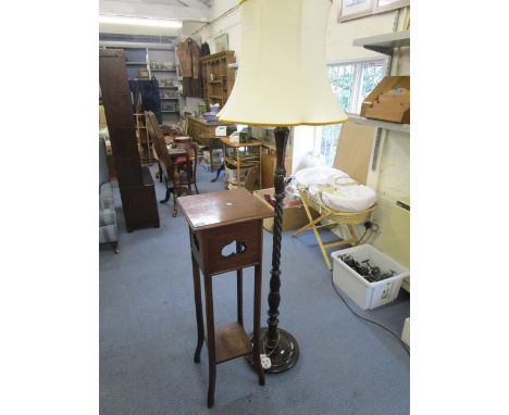 A standard lamp with shade and a mahogany plant stand 