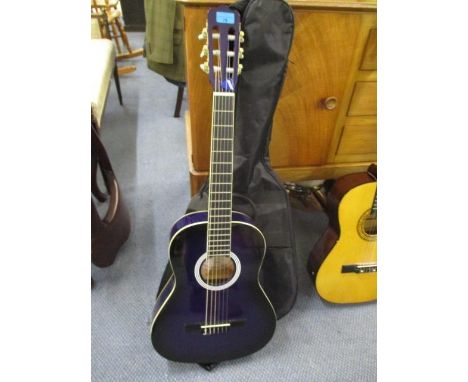 A brand new Ashton purple, six string acoustic guitar with gig bag 