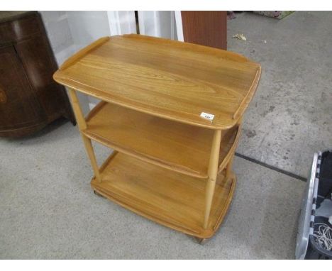 A light Ercol three tier trolley and a pair of Ercol three tier what nots, together with a light Ercol wall hanging shelf 