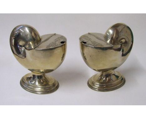 Pair C19th Hard Metal Silver Plated Spoon Warmers in form of nautilus shells, on oval domed feet (2) 