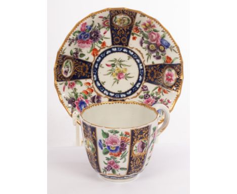 A Worcester fluted coffee cup and saucer, painted alternating panels of bouquets of flowers on a white ground and flower spra