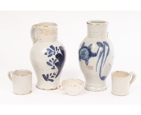 Two London Delftware tavern measures, circa 1790-1820, baluster shape with grooved necks, crude blue decoration on the fronts