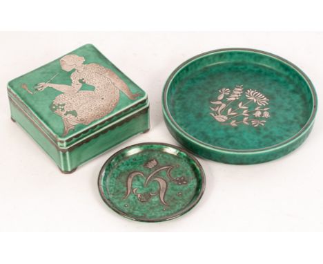 Wilhelm Kage for Gustavsberg, an Argenta box, the cover decorated with a seated lady smoking, 9cm wide, a circular dish with 