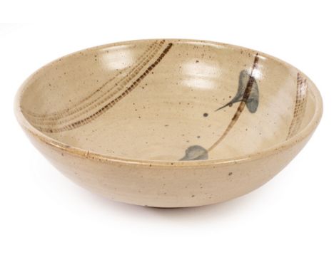 Bernard Leach (1887-1979), a stoneware shallow bowl, circa 1964, made at St Ives, with a painted leafy stem between rouletted