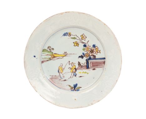 An English Delftware plate, probably Bristol, circa 1750-60, with a 'bianco sopra bianco' border, painted in polychrome with 