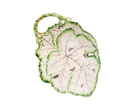 An early Worcester leaf dish, circa 1755-56, moulded in the shape of vine leaves with an applied stalk handle, painted with s