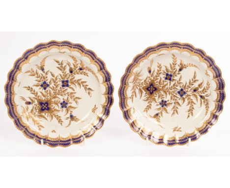 A pair of Worcester porcelain scalloped small plates, circa 1775, blue crescent marks, each painted in underglaze blue and gi
