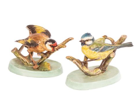 A very rare pair of Royal Worcester models by Doris Lindner, (1896-1979), of a blue tit and a chaffinch perched on stumps on 