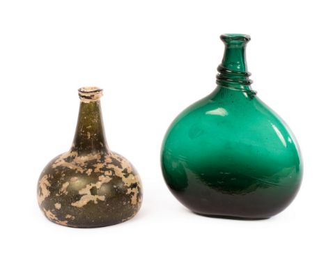 An 'onion' wine bottle, early 18th Century, with trailed rim and kick-in base, in dark bottle green with evidence of burial, 