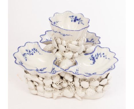 A Worcester or Caughley triple salt or sweetmeat stand, circa 1780, encrusted with modelled shells and painted with sprigs in