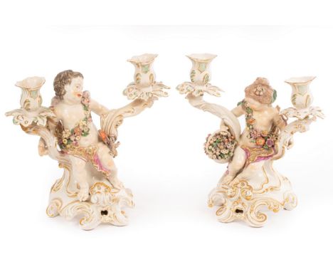 A pair of Chelsea gold anchor figural two-light candelabra, garlanded cherubs, 26cm high/see illustration CONDITION REPORT: B