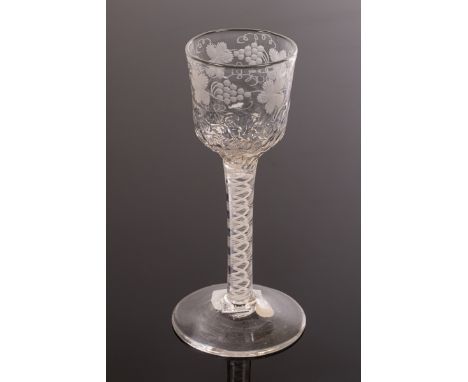 An 18th Century wine glass, the ogee bowl engraved band fruiting vine above a honeycomb moulded base on a 10-ply spiral band 