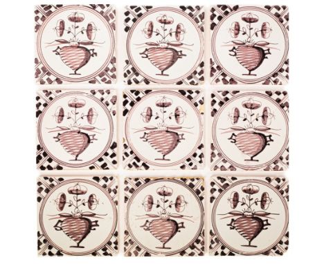 A set of nine Dutch Delft tiles, probably Makkum, circa 1800, painted in manganese with a formal flower vase within circular 