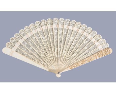 Ω A Chinese ivory brise fan, Canton, first quarter of the 19th century, each pierced stick carved intricately on both sides w