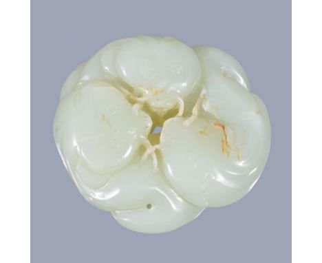  A Chinese celadon jade carving of three catfish,   probably circa 1880-1920, with russet jade inclusions, the heads all faci