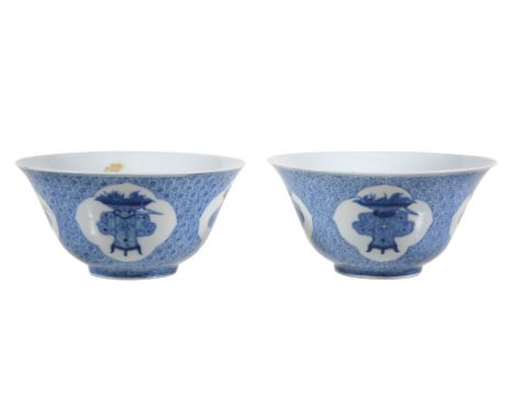  A pair of Chinese blue and white bowls,   the exteriors finely painted with four quatrefoil reserveswith vases of flowers on