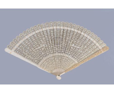 Ω A large Chinese ivory brise fan, Canton, first quarter of the 19th century, each pierced stick intricately carved on one si