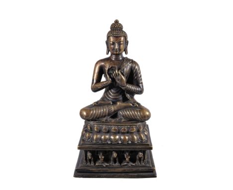  A brass alloy figure of Buddha,   Western Tibet, 14th/15th century or perhaps later, seated in  padmasana   on a double lotu