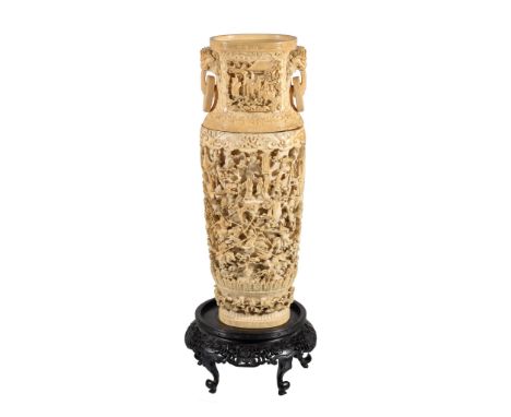 Ω A large Cantonese ivory two-handled vase, early 19th century, intricately carved in two parts, in a high-relief with a cont