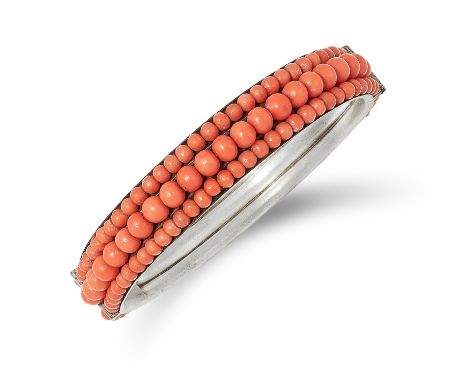 CORAL BANGLE set with three rows of coral beads, 6cm inner diameter, 23.7g.