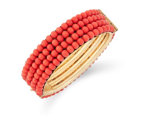 CORAL BANGLE set with four rows of coral beads, 6cm inner diameter, 46.1g.