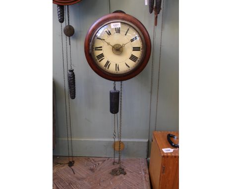 A late 19th Century 'Postmans' alarm clock with moulded mahogany surround to a spun brass bezel to a painted Roman dial with 