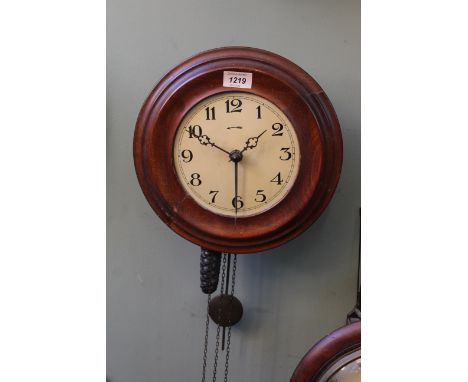 An early 20th Century walnut 'Postman's Alarm' wall clock, moulded and quartered surround to composite Arabic dial with pierc