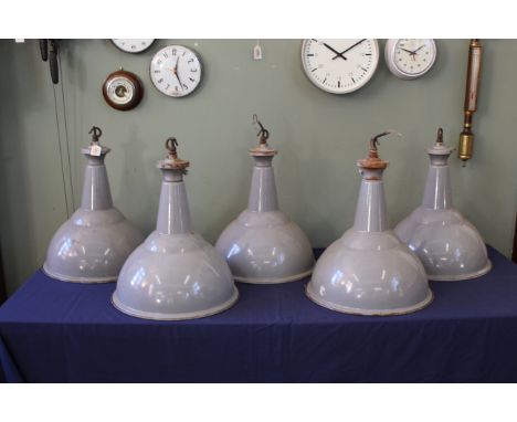 Five mid 20th Century grey enamelled industrial lamp shades, each of bell form and with white lined interiors and metal mount