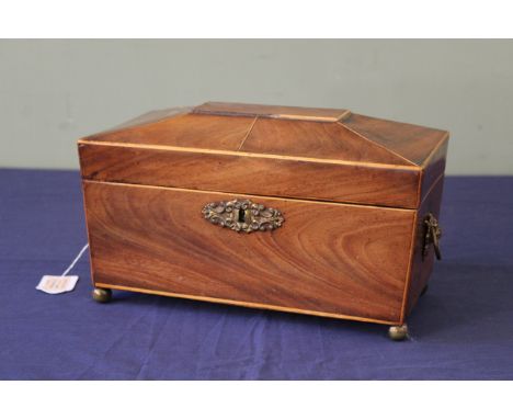 An early 19th Century mahogany and boxwood line inlaid tea caddy, of sarcophagus form, with ring side handles, fitted interio
