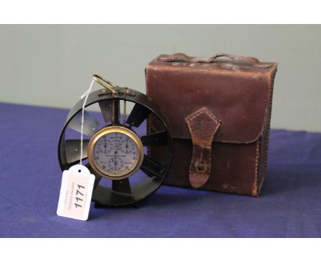 A mid 20th Century, leather cased, black lacquered anemometer, unsigned, the cylindrical case with loop suspension and silver