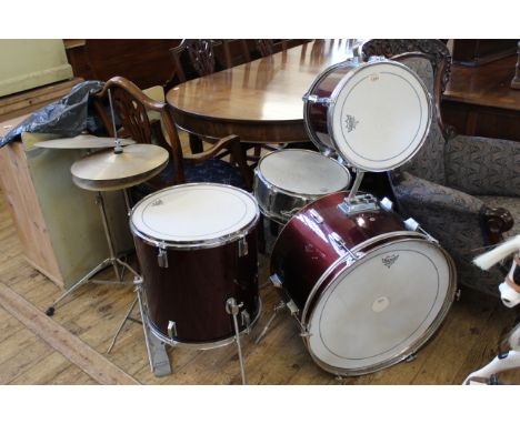 A vintage cherry red drum kit with cymbals 