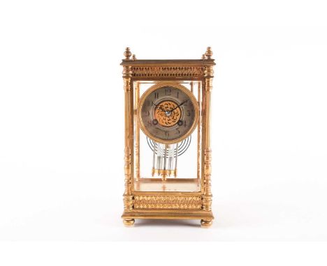 A late 19th century gilt brass and four glass mantel clock, with silvered circular dial and twin mercurial compensating pendu