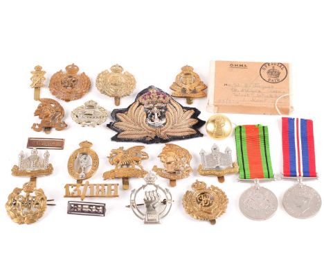 A small collection of military cap badges, to include Artists, Artist Rifles, Royal Armoured Corp, Cambridgshire regiment, Ro