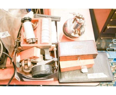 A vintage, engravers/watchmakers ball vice and dogs with leather cushion together with other jewellers/ watchmakers hand tool