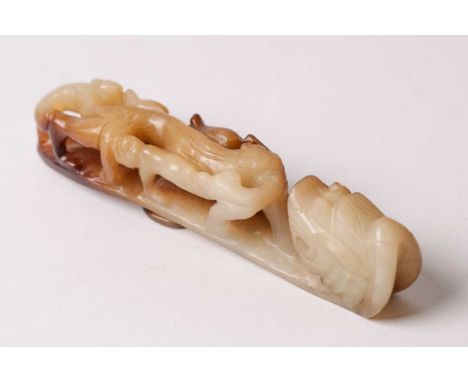 A Chinese jade belt hook, late Ming/early Qing, the pierced body carved with a chilong, terminating in a dragon's head, the s