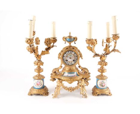 A late 19th century Japy Freres ormolu clock garniture. Mounted with Sevres style porcelain panels painted with figures in Wa